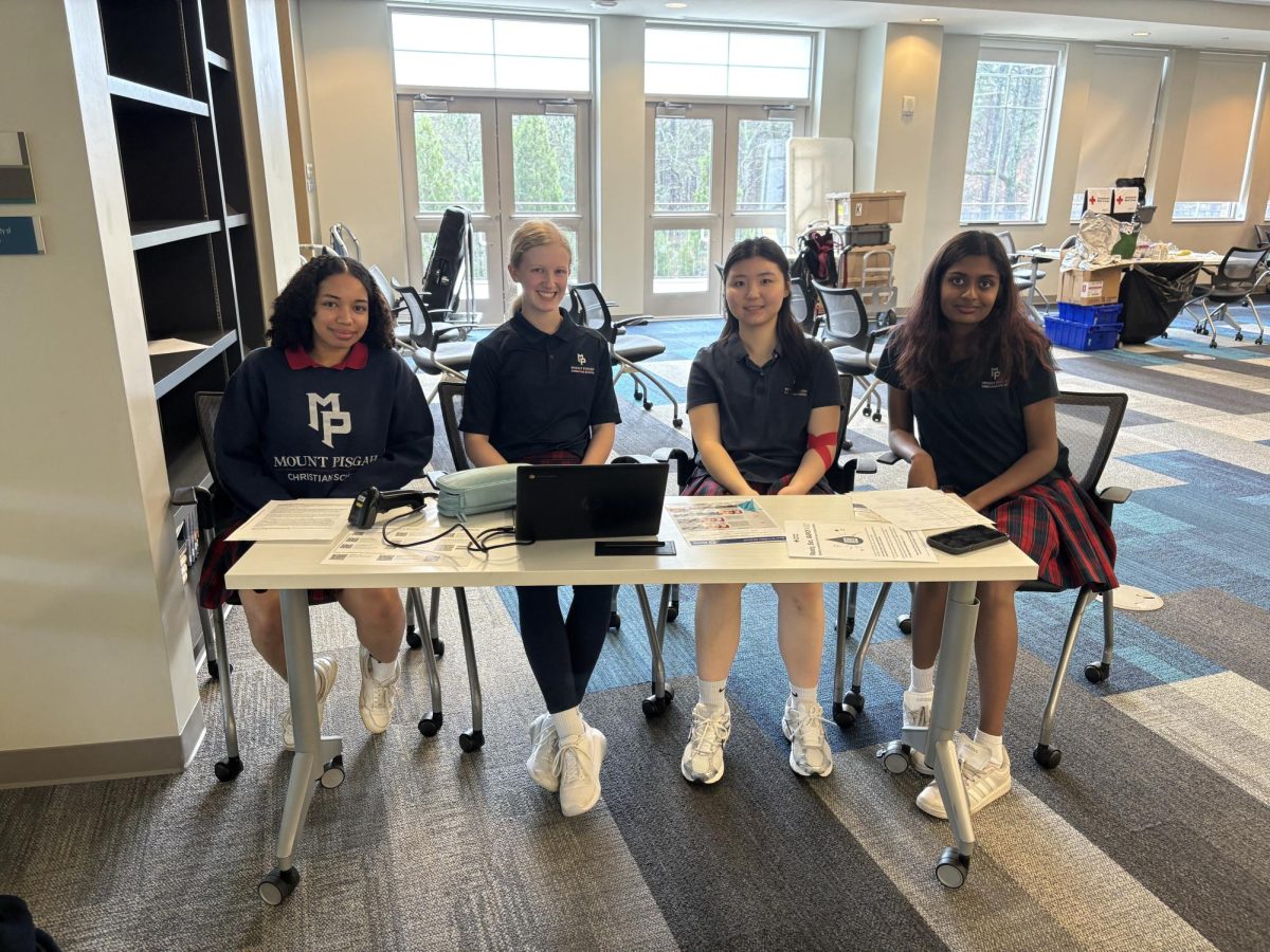 Seniors Purity Stevens, Adelynn Tuck, Nancy Xue and Jerusha Johnson checking people in to donate blood.
